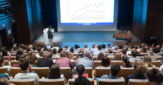 Crowd listening to an event speaker at a healthcare sales meeting